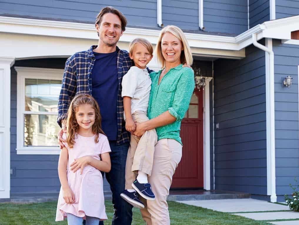 Happy Family in Front of House