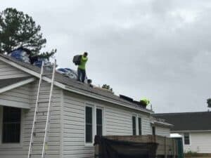 a man standing on top of a roof.