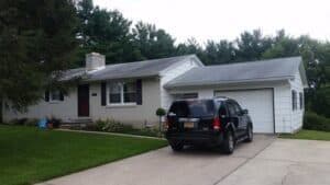 a car is parked in front of a house.