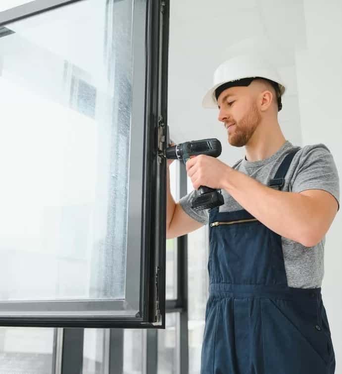 Worker Drilling Windows